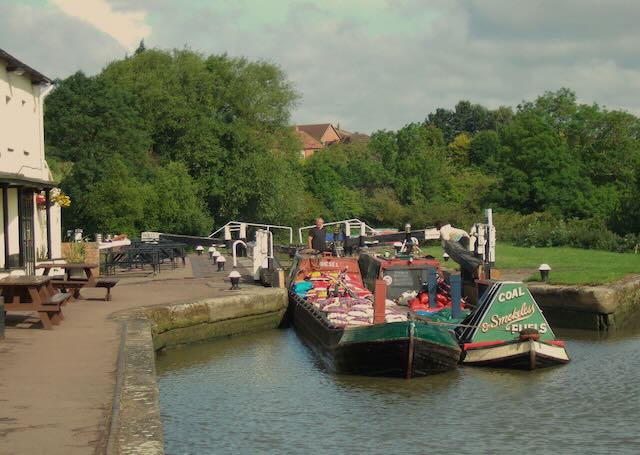 Coal boats Bletchley and Roach passing through Soulbury Locks on the Grand Union Canal.